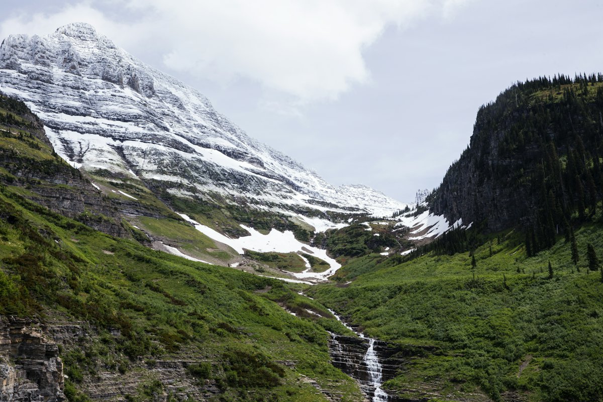 A road winding below snowy peaks in a US mountain park