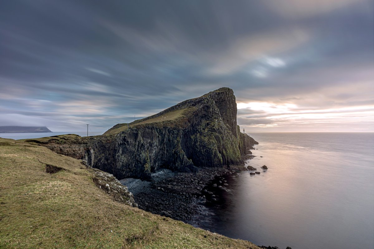 A rocky headland on the UK coast at dusk