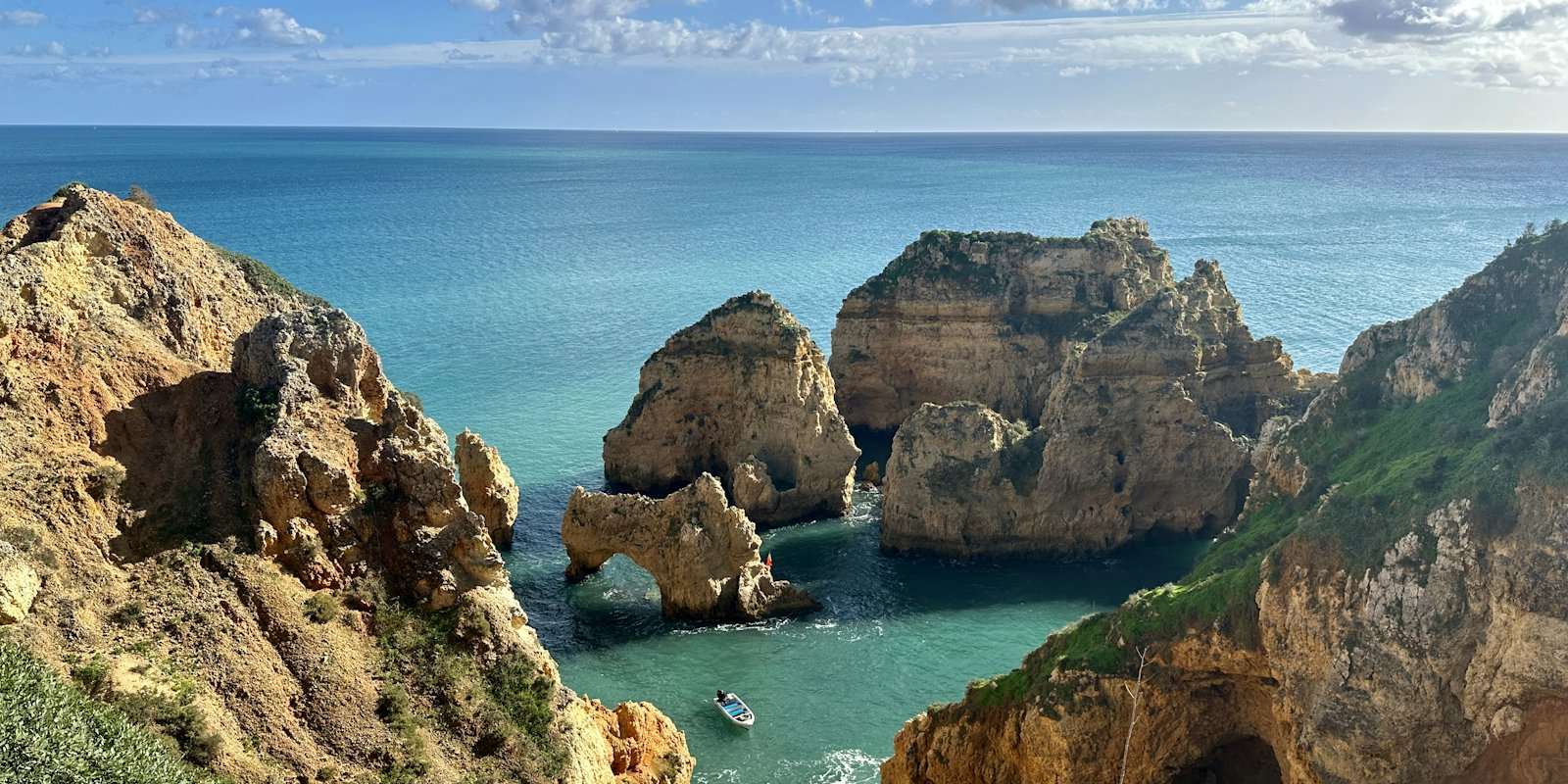 Golden sandstone cliffs and sea stacks on Portugal's southern coast