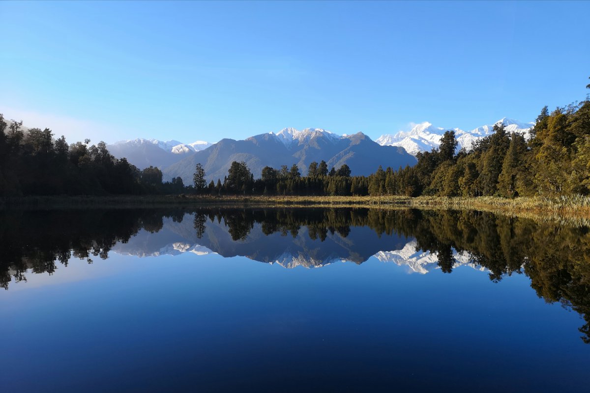 Lake Matheson reflecting the Southern Alps and rainforest